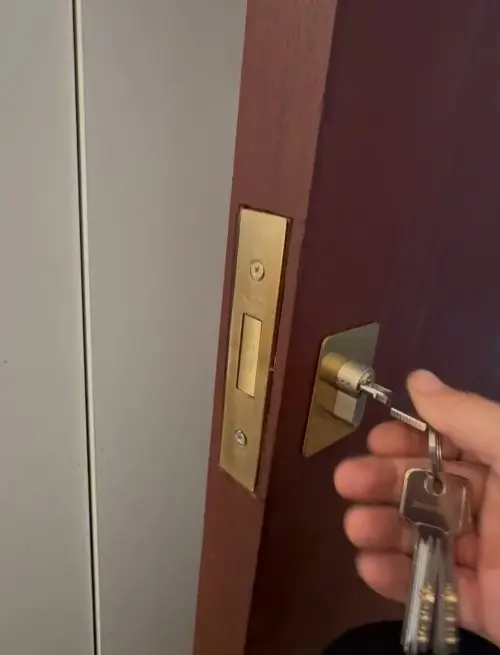 professional locksmith fixing a loose cylinder